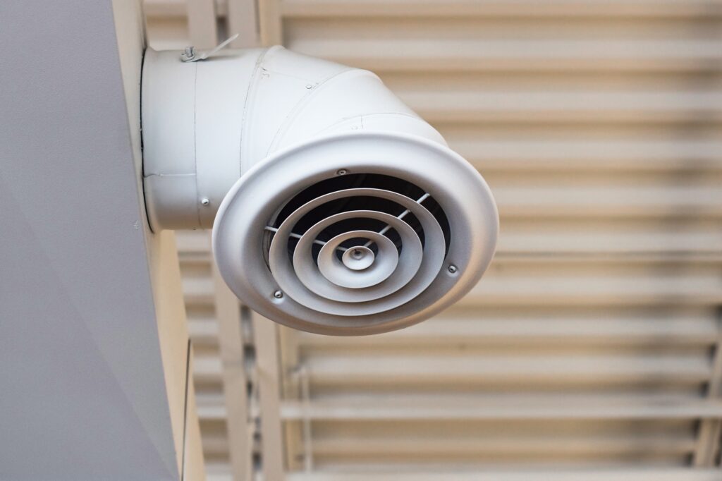 Exposed white industrial ceiling ventilation system